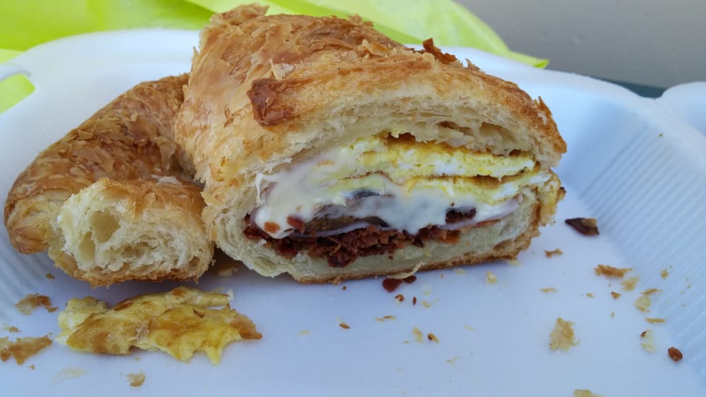 Croissant breakfast sandwich with egg and bacon