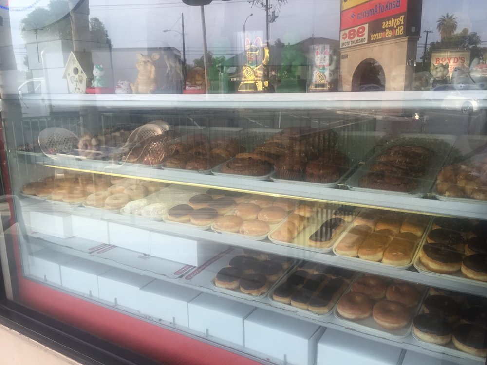 Shelves of donuts in the front case